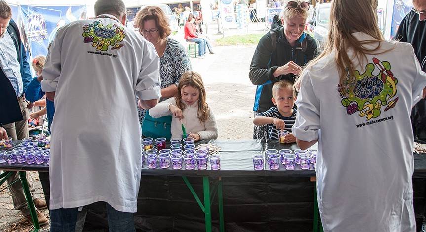 Mad science party room with illustrations on the wall and a picture of a mad scientist and child performing an experiment