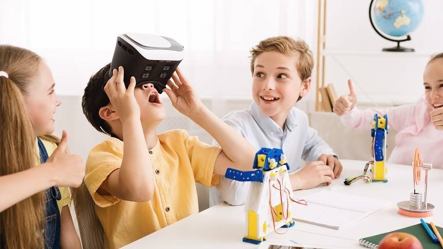 2 boys wearing mad science lab coats working on their mad science loop lab box competing one of the experiments