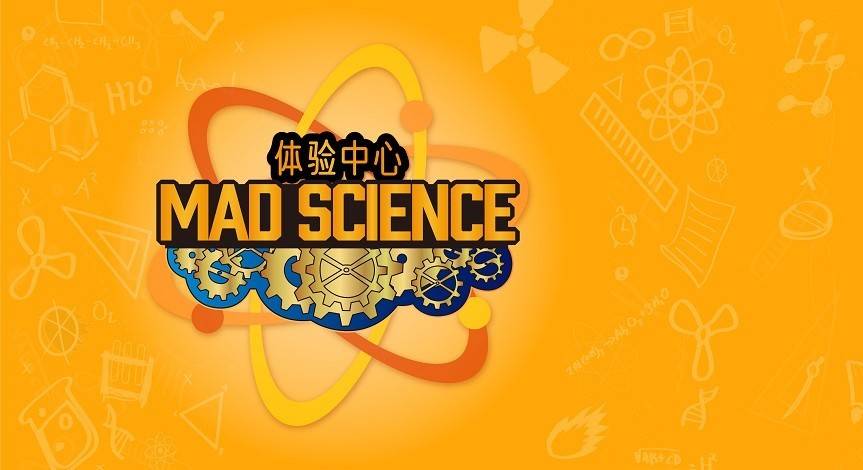 2 boys wearing mad science lab coats working on their mad science loop lab box competing one of the experiments